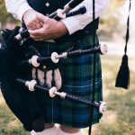 Man in kilt holding bagpipes